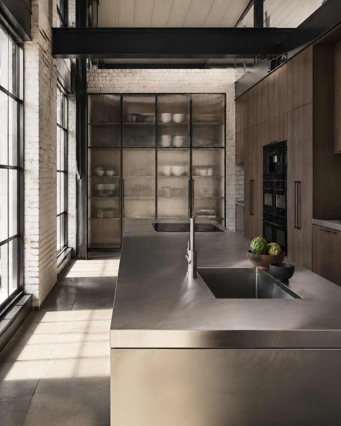 Cocina de acero inoxidable con ventanales de perfil negro